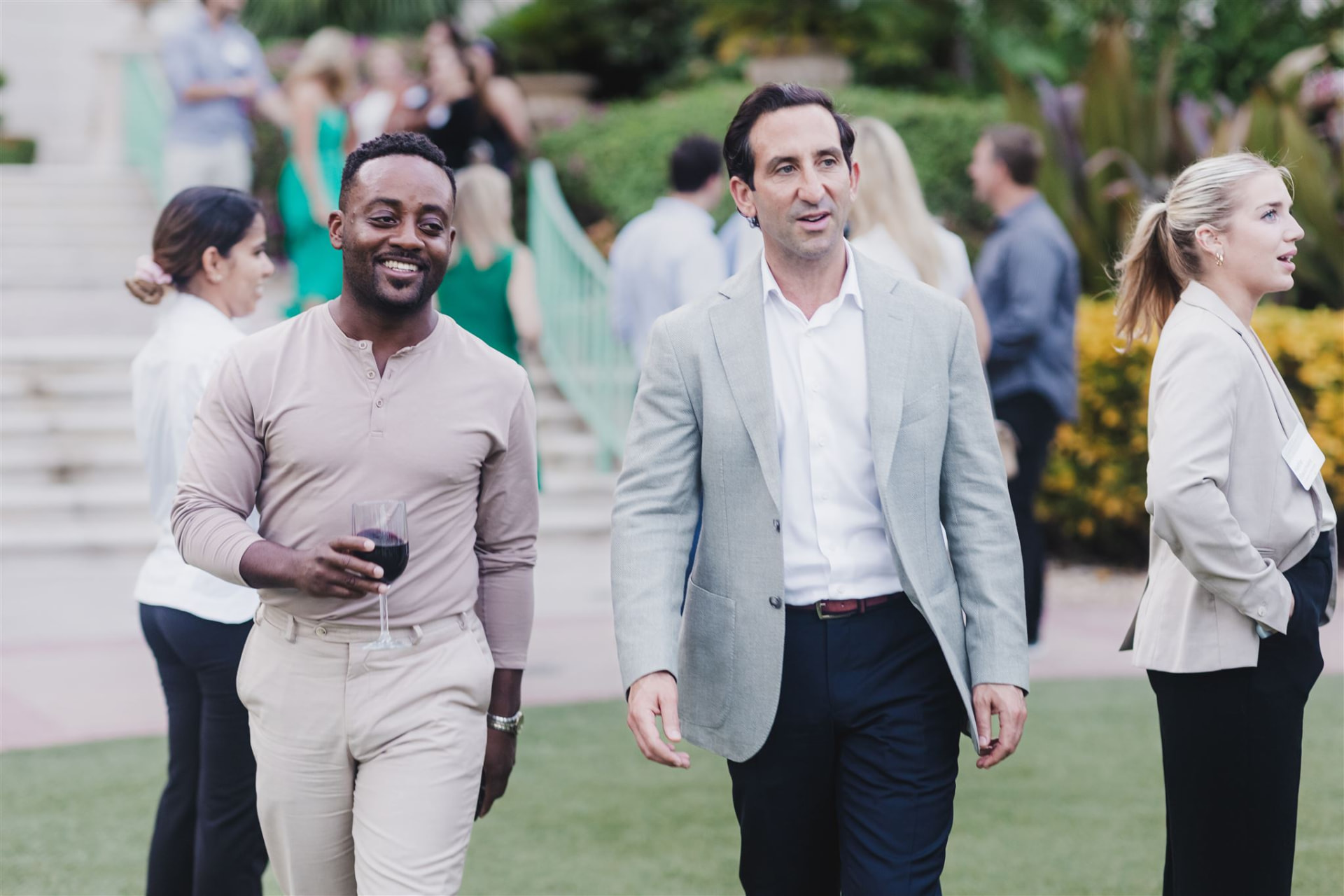Business leaders in conversation at an outdoor networking event